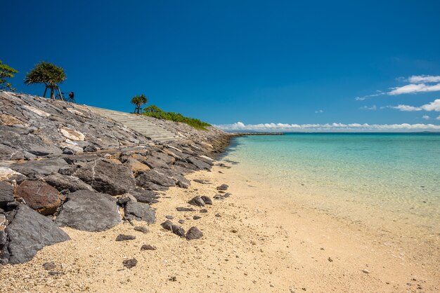 Cycling along the shore turquoise sea off maehama beach japan