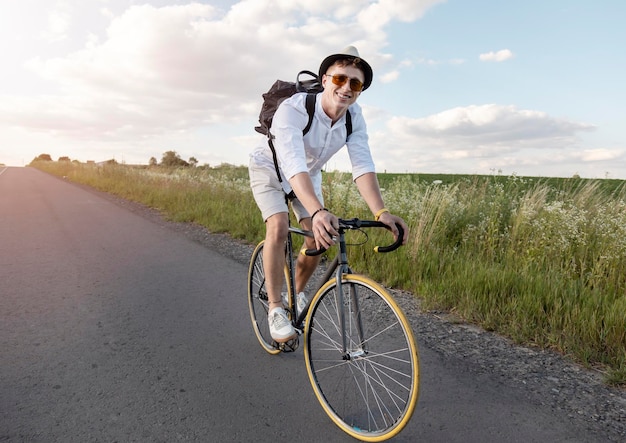 Cycling male tourist smiles at camera