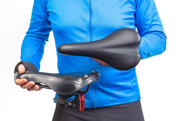 cyclist inspects compares and selects a saddle for a bicycle