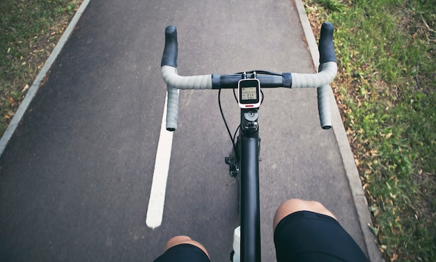 The cyclist is moving through the asphalt road