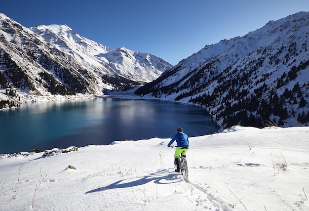 Cyclist ride in winter mountains