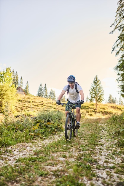 A cyclist rides a bike on extreme and dangerous forest roads\
selective focus