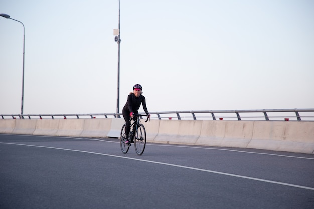 Cyclist rides over the bridge in the city