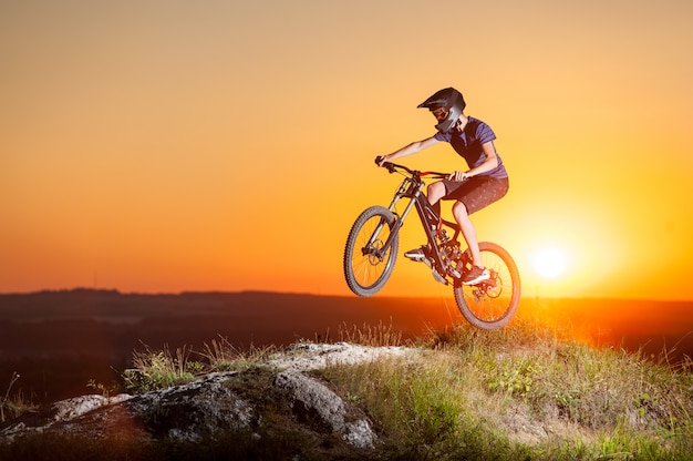 Cyclist riding downhill on mountain bike on the hill