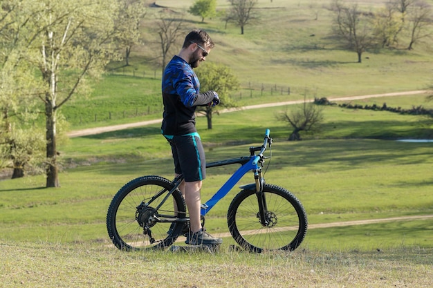 Cyclist in shorts and jersey on a modern carbon hardtail bike with an air suspension fork