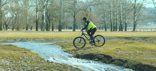 Cyclist in shorts and jersey on a modern carbon hardtail bike with an air suspension fork