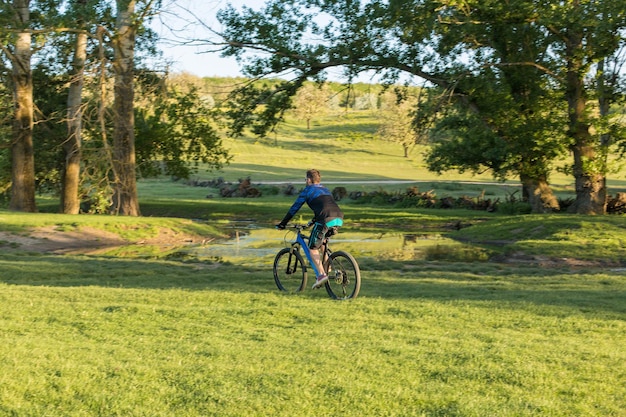 Cyclist in shorts and jersey on a modern carbon hardtail bike with an air suspension fork