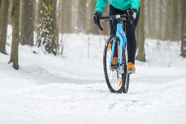 Cyclist in the snowy forest