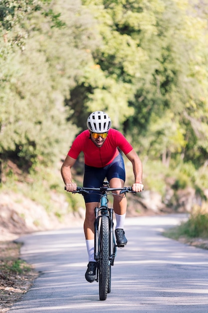 Cyclist training with mountain bike on a road