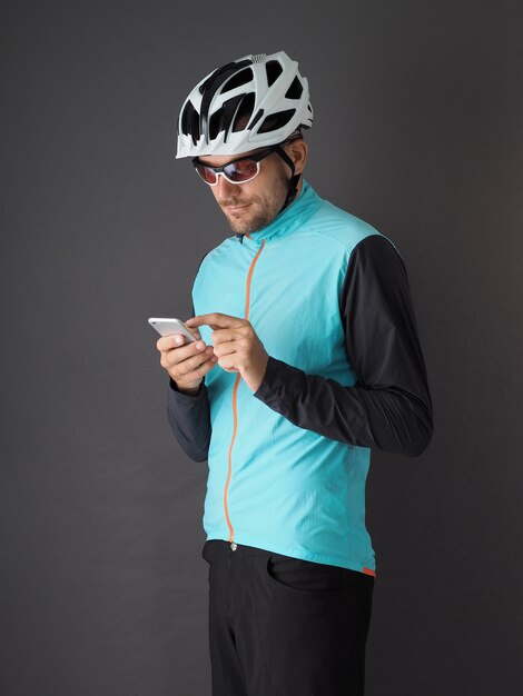 A cyclist uses a smartphone portrait