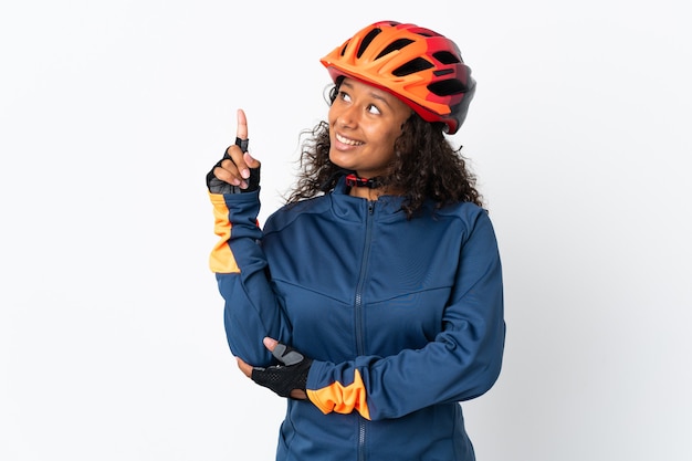 Cyclist woman isolated on white pointing up a great idea