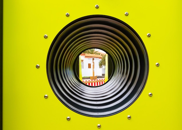 Cylindrical tube in yellow background, closeup of photo