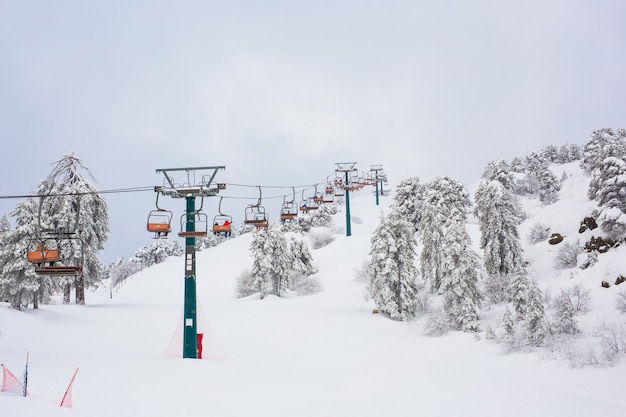 Cyprus Ski lifts and cable cars going up the mountain bringing snowboarders to ski slopes.