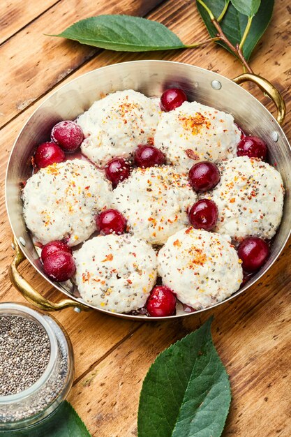 Czech dumplings or knedliky with cherry filling on wooden table