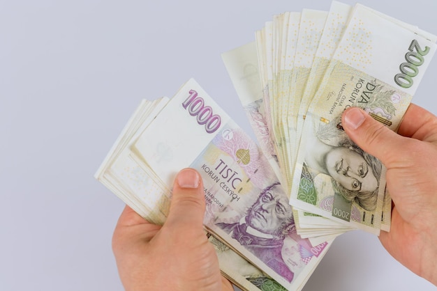 Czech koruna currency banknotes in the hands of a man