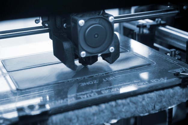 d printer close up a working d printer in process of printing object from molten plastic d printer