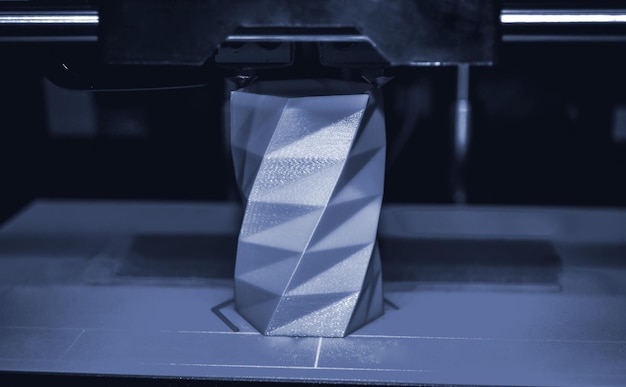 D printer works and creates an object from the hot molten plastic