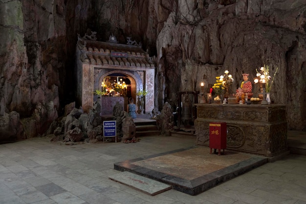 Da Nang Vietnam August 21 2018 Woman praying at a shrine inside of the Huyen Khong Cave in the Marble Mountains Da Nang