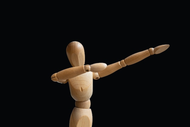 Do the dab. wooden puppet on black background. isolated image