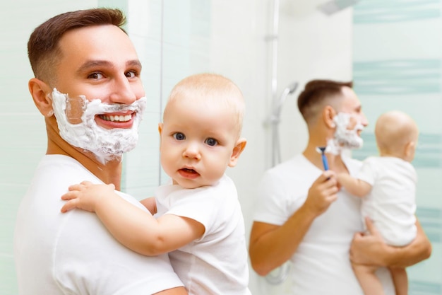 Dad and baby son shave in the bathroom