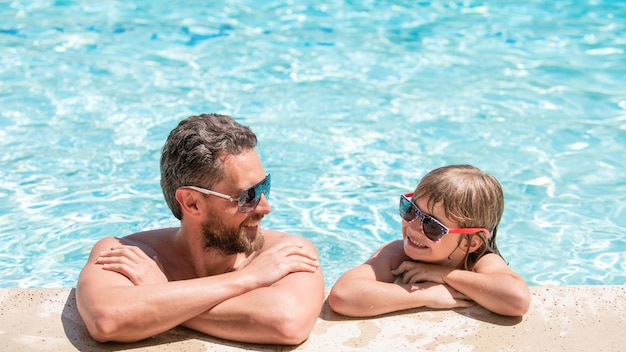 Dad and child having fun at pool party childhood and parenting father and son