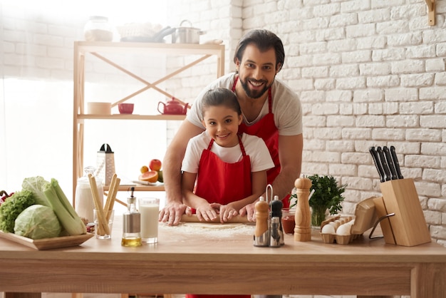 Dad and Daughter are Rolling Out Dough on Kitchen.