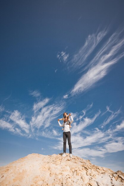 Dad and daughter on the background of clouds 3316