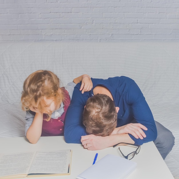 The dad and daughter do homework after primary school