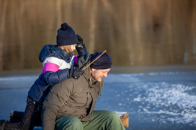 Dad and daughter play on ice