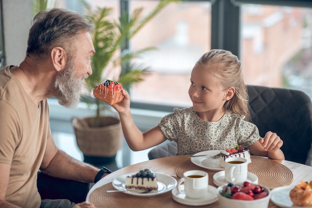 Dad and his daughter having breakfast together at home