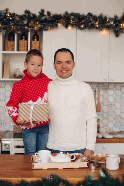 Dad hugs his son and looks at the camera