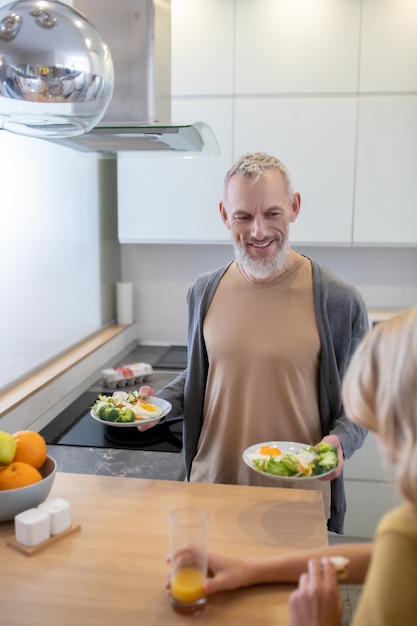 Dad making breakfast for his blonde daughter