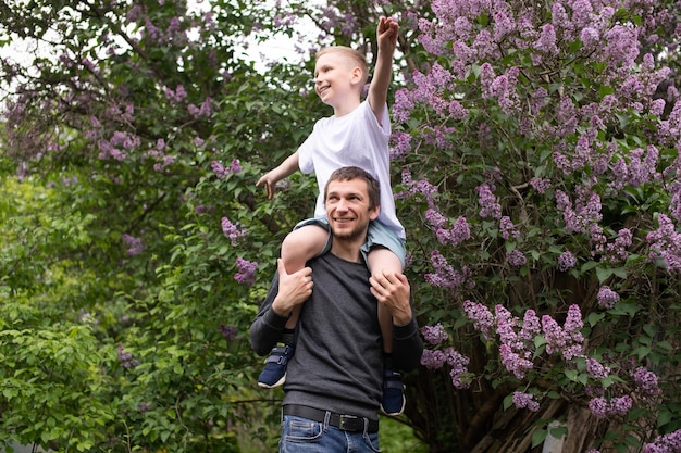 Dad picked up and put a cute child on his shoulders Son flies like a plane