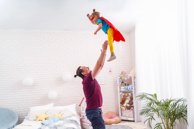 Dad playing superheroes with his child