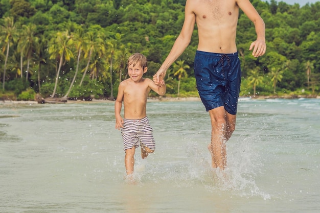 Dad plays with his son in the sea