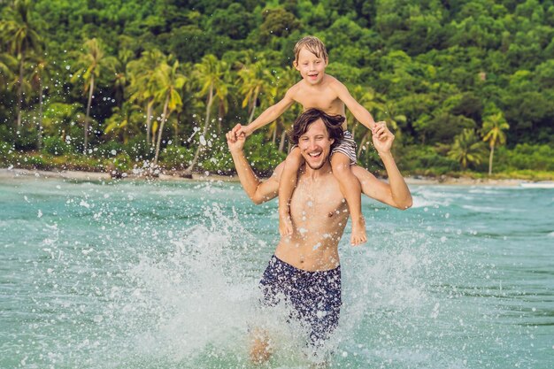 Dad plays with his son in the sea