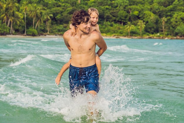 Dad plays with his son in the sea