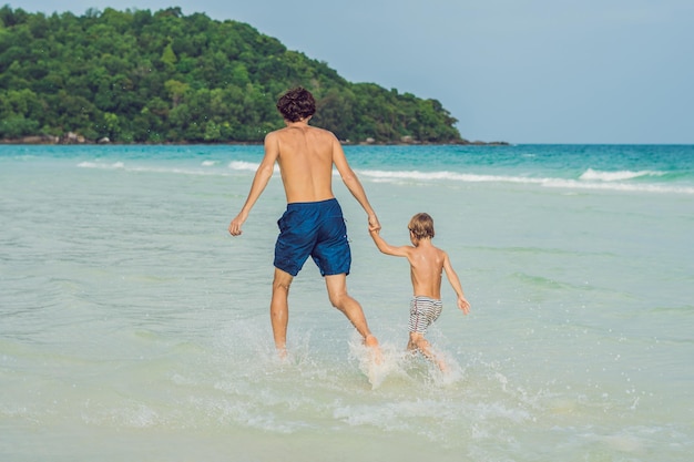 Dad plays with his son in the sea