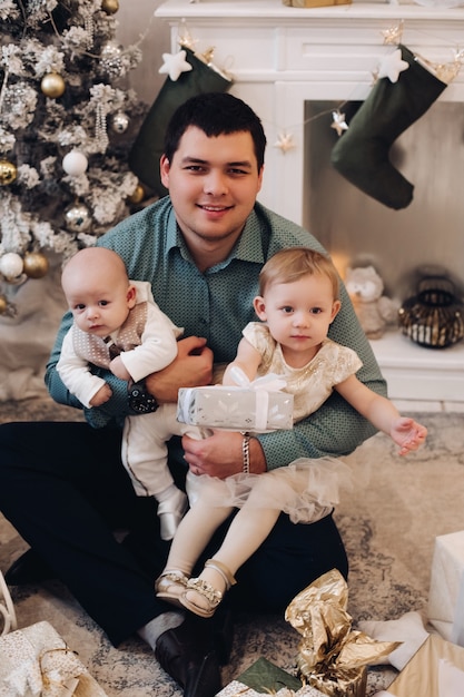 Dad posing with his kids on christmas day