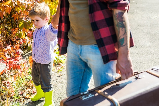 Dad and son in the autumn park play laughing kid and his father are in autumn park