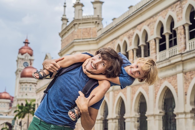 Dad and son on background of Sultan Abdul Samad Building in Kuala Lumpur, Malaysia. Traveling with children concept