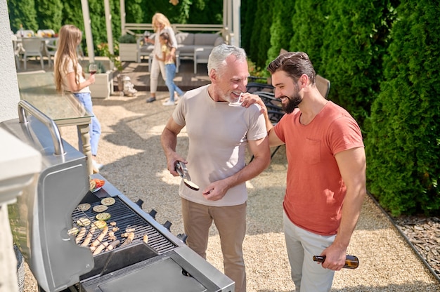 Dad and son. Dad and son cooking together at the back yard