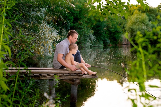 Dad and son fishing on a lake