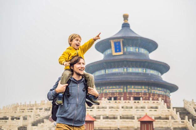 Dad and son travelers in the Temple of Heaven in Beijing One of the main attractions of Beijing Traveling with family and kids in China concept