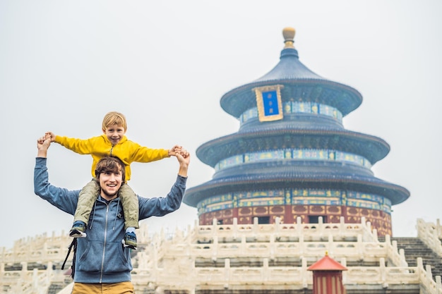 Dad and son travelers in the Temple of Heaven in Beijing One of the main attractions of Beijing Traveling with family and kids in China concept