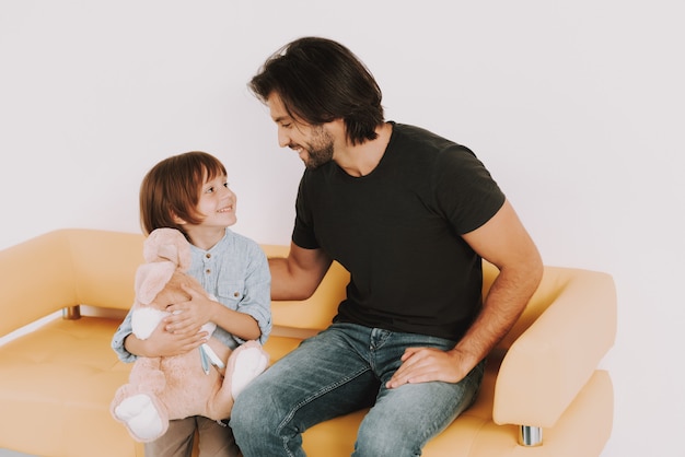 Dad and Son with Bunny Toy at Doctor Waiting Room.