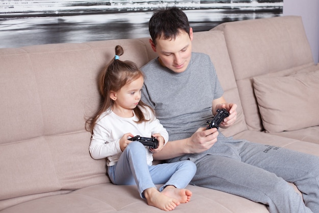 Dad teaches his daughter to play video games Gamers