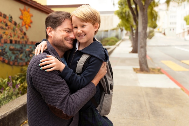 Photo dad walking his kid at first day of school