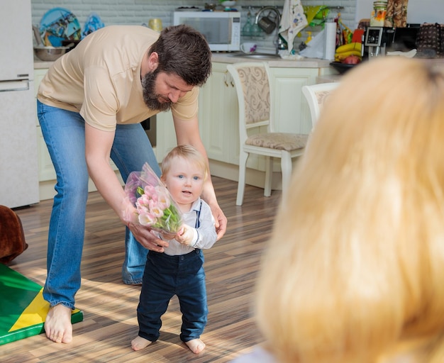 Dad with baby son congratulate mom on the holiday