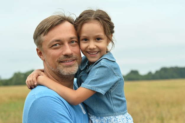 Dad with his daughter playing in field